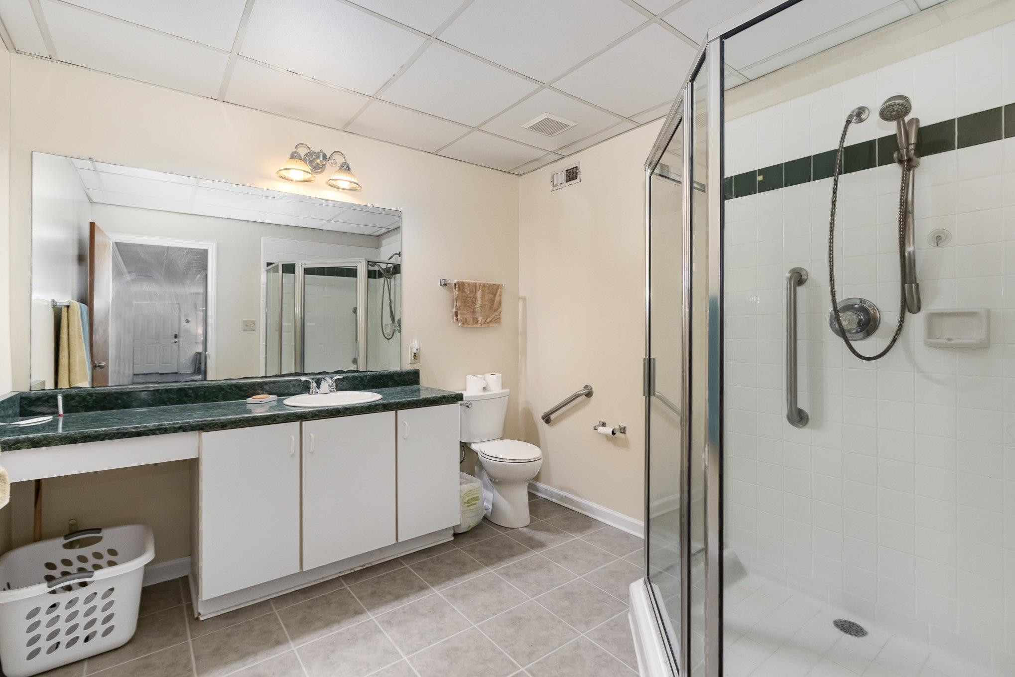 3200 Twin Streams Road Chapel Hill, NC 27516 - Photo 30 of 46 a bathroom with a granite countertop sink a mirror and a shower