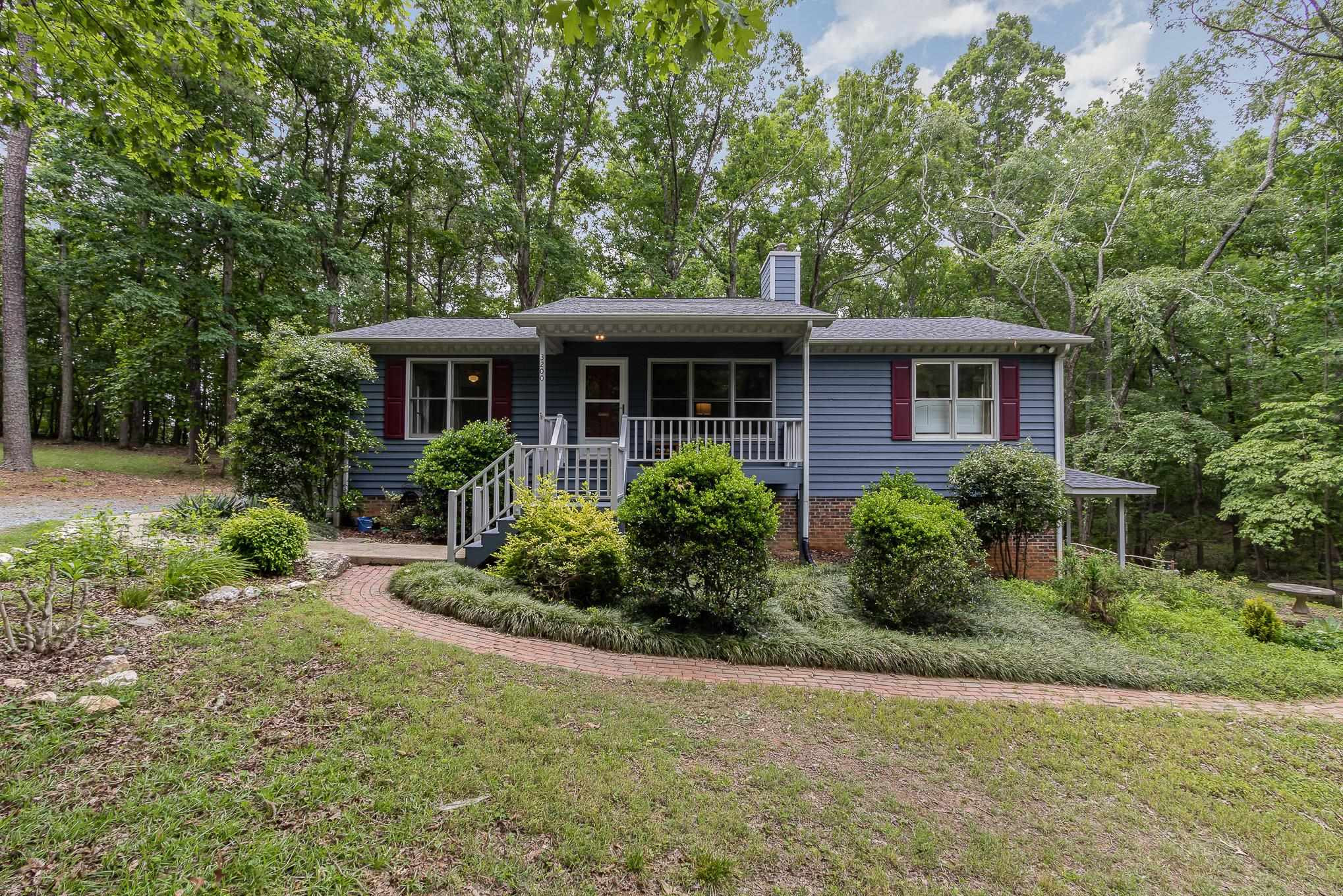 3200 Twin Streams Road Chapel Hill, NC 27516 - Photo 3 of 46 a front view of house with yard and green space