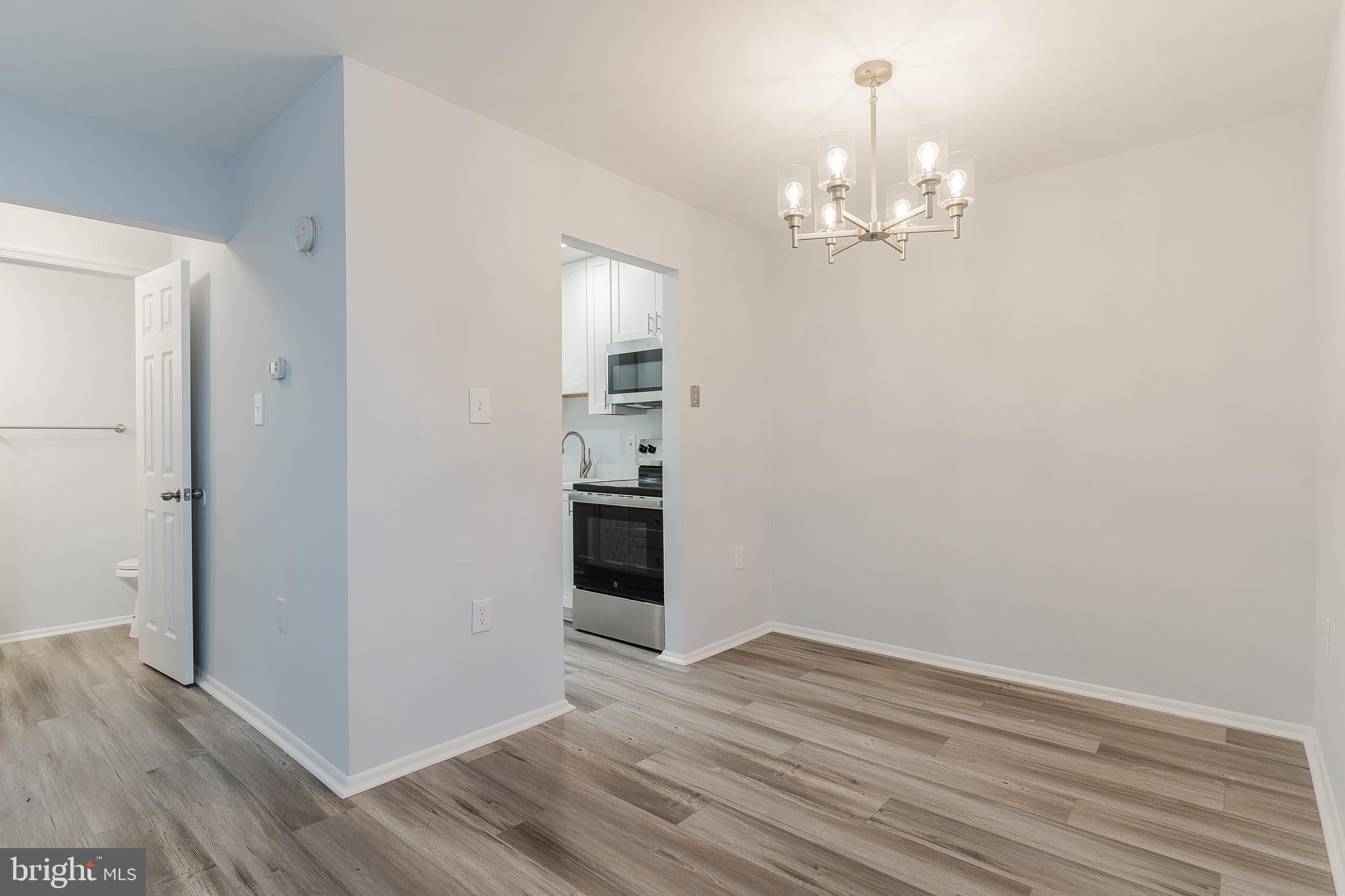 8708 Village Square Drive Alexandria, VA 22309 - Photo 13 of 46 wooden floor in an empty room with a window