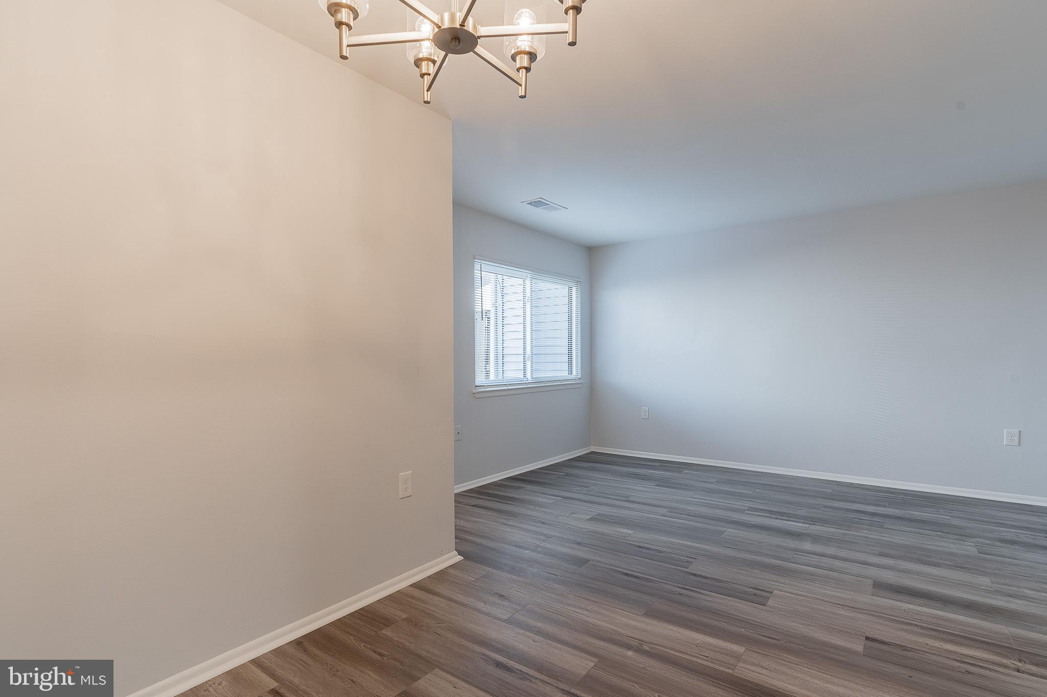 8708 Village Square Drive Alexandria, VA 22309 - Photo 14 of 46 wooden floor in an empty room with a window