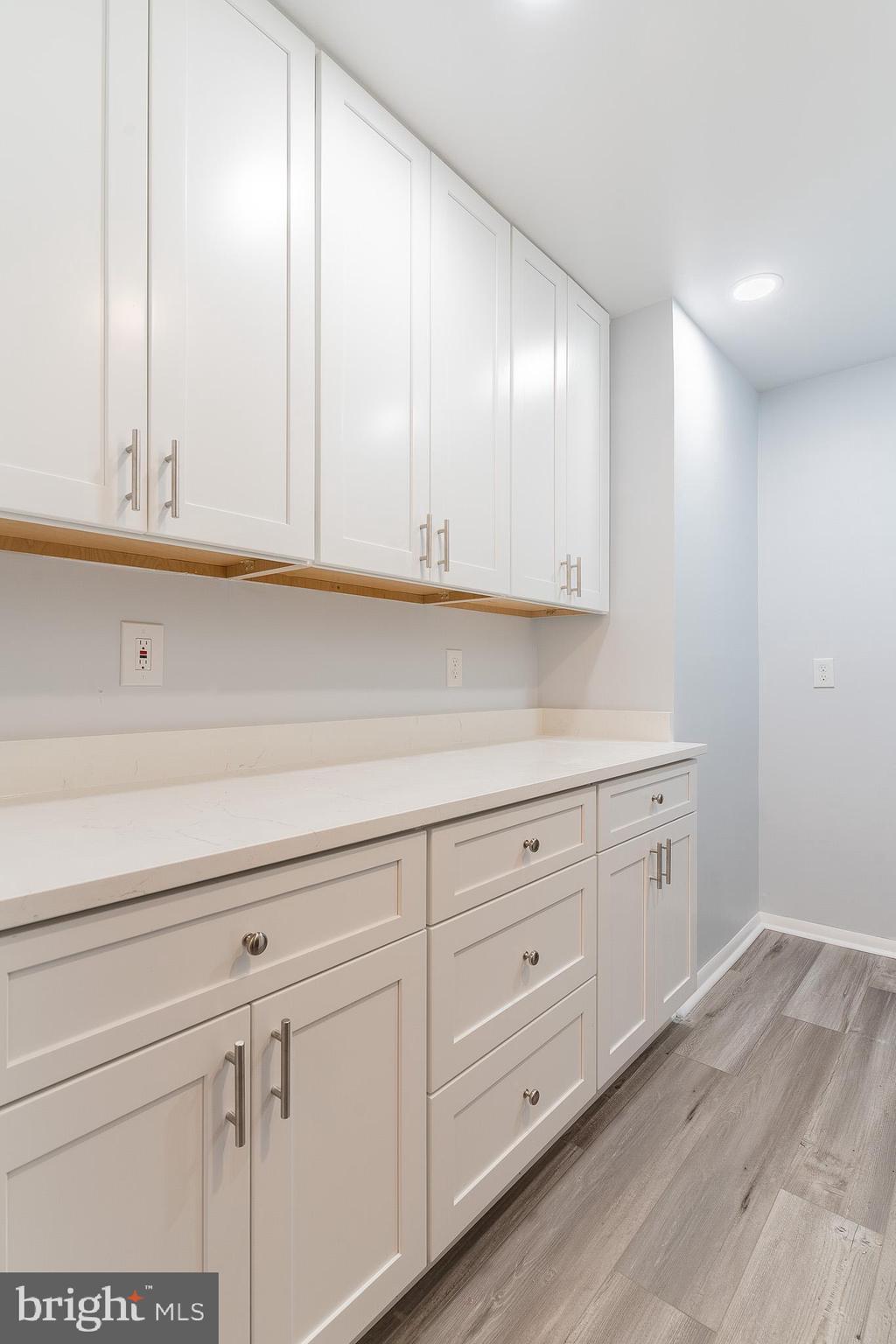 8708 Village Square Drive Alexandria, VA 22309 - Photo 18 of 46 a kitchen with granite countertop white cabinets and white appliances
