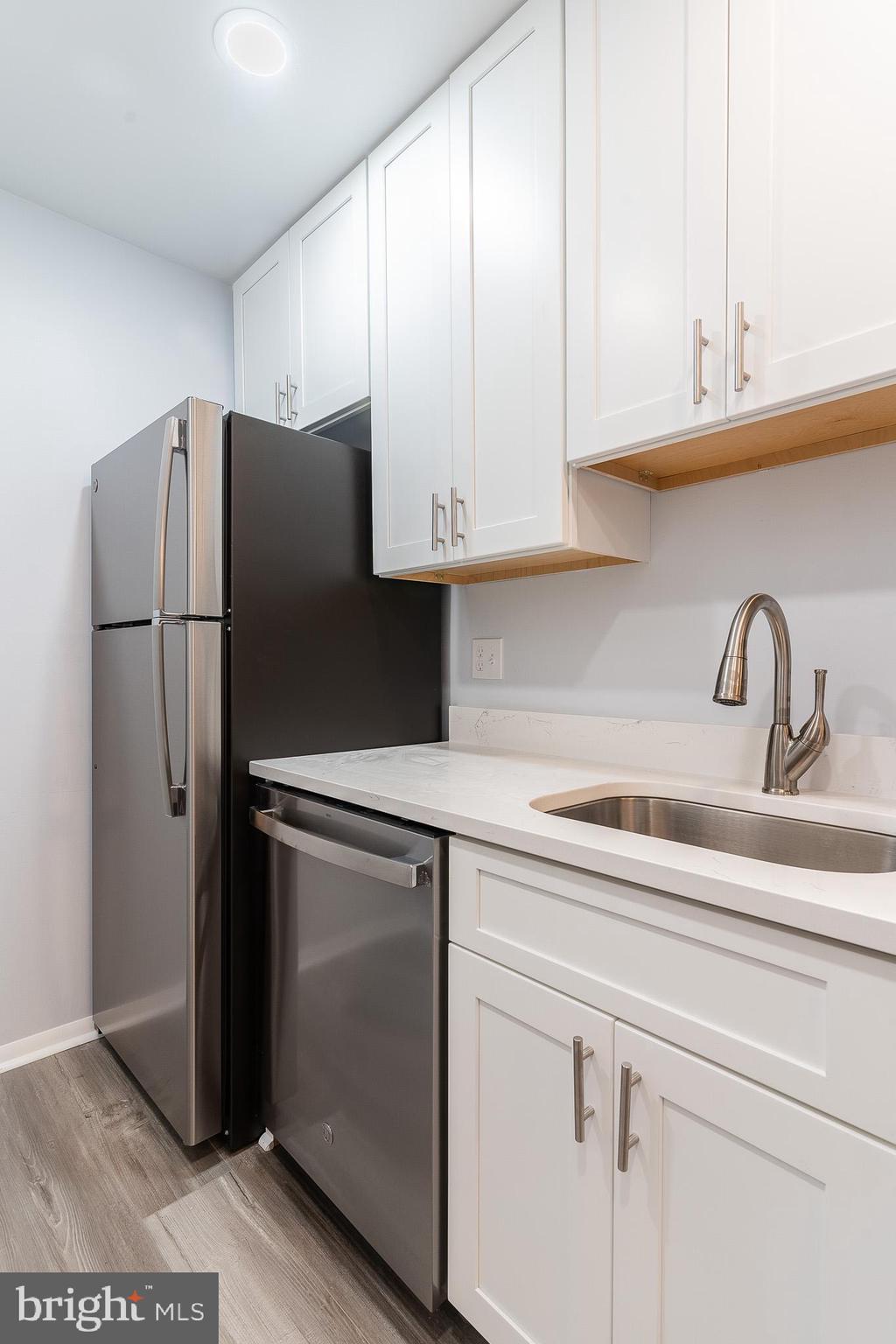 8708 Village Square Drive Alexandria, VA 22309 - Photo 19 of 46 a kitchen with stainless steel appliances white cabinets and a refrigerator