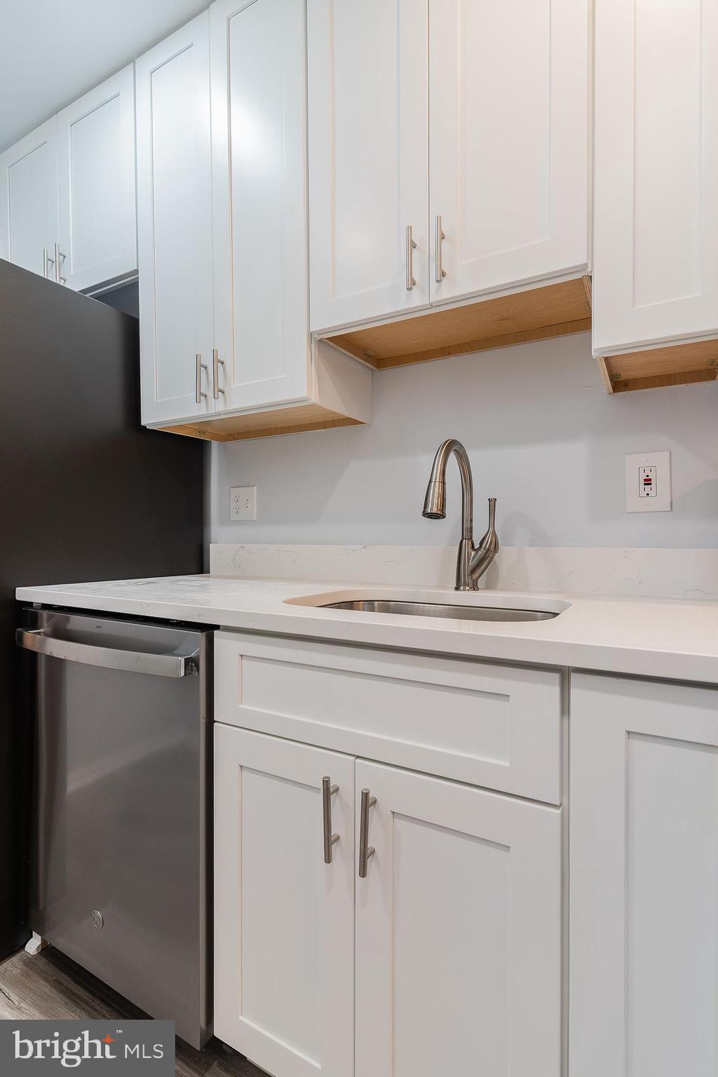 8708 Village Square Drive Alexandria, VA 22309 - Photo 27 of 46 a kitchen with white cabinets and a sink