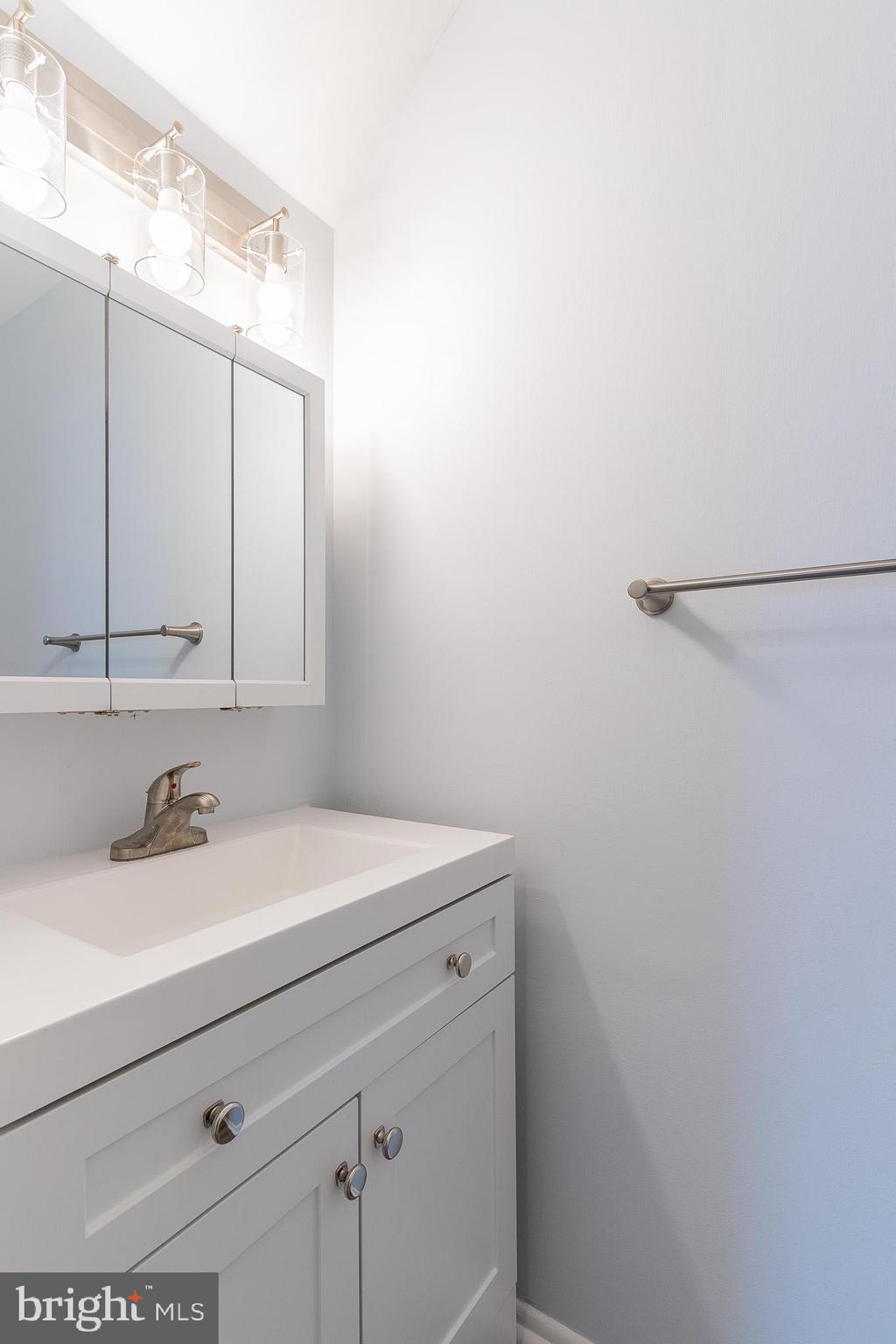8708 Village Square Drive Alexandria, VA 22309 - Photo 30 of 46 a bathroom with a sink and a mirror