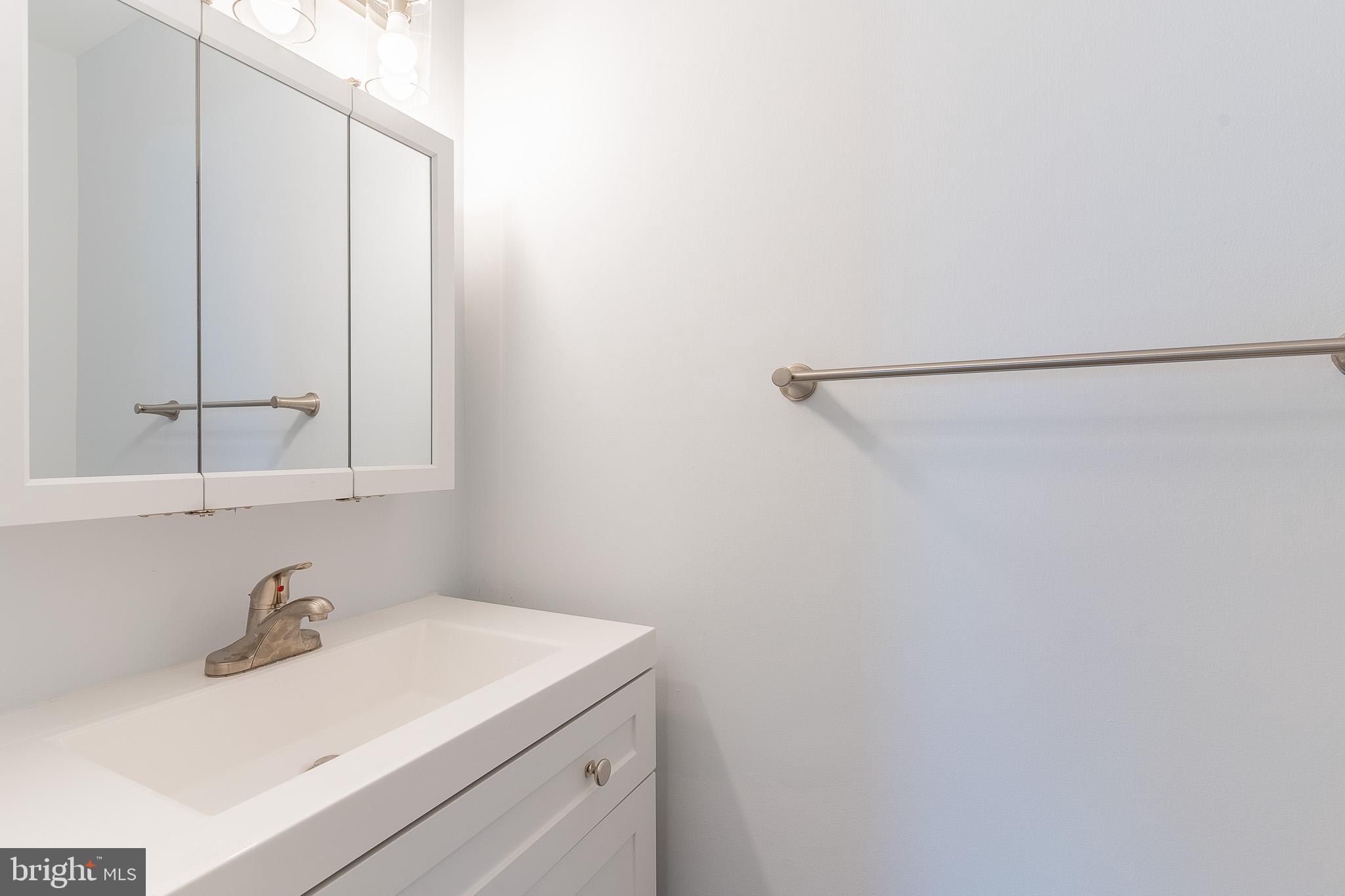 8708 Village Square Drive Alexandria, VA 22309 - Photo 31 of 46 a bathroom with a sink and a mirror