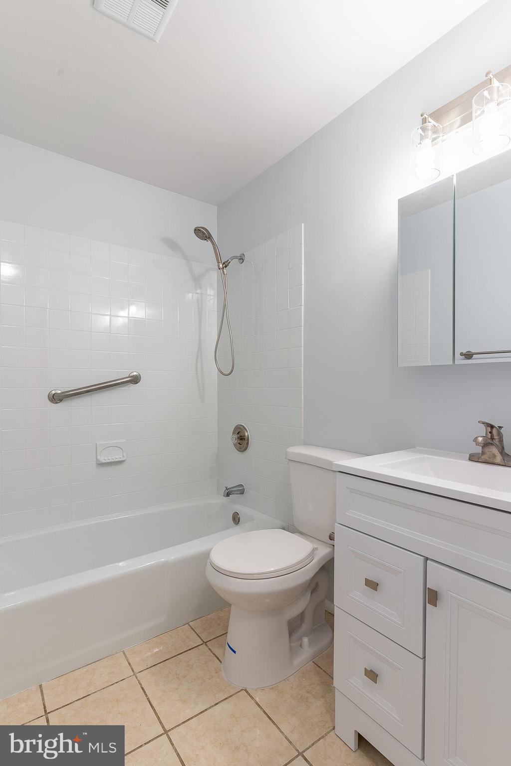 8708 Village Square Drive Alexandria, VA 22309 - Photo 39 of 46 a bathroom with a sink a toilet and shower