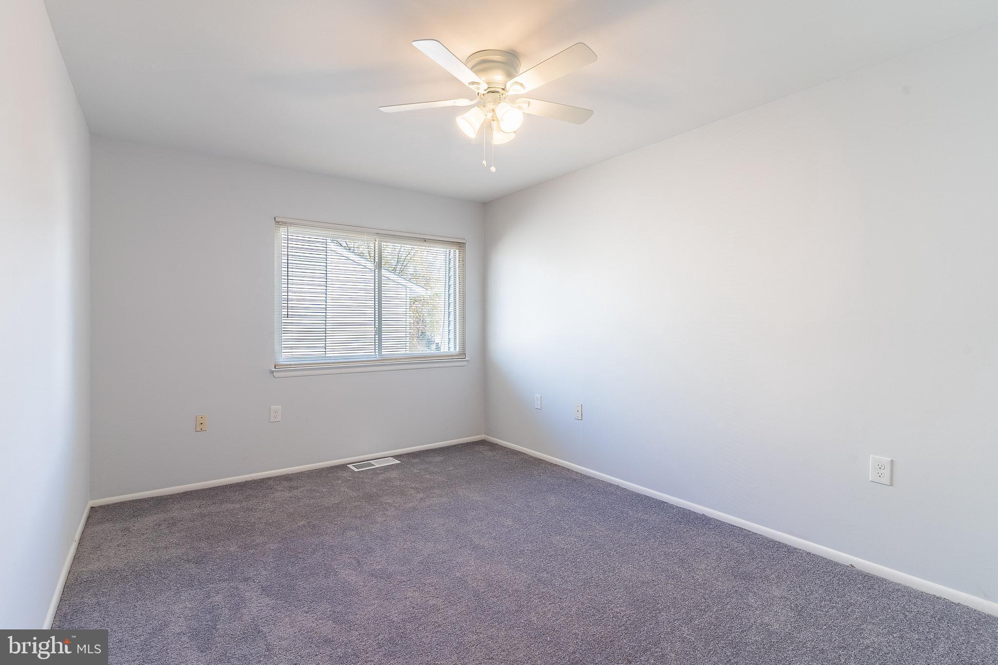 8708 Village Square Drive Alexandria, VA 22309 - Photo 43 of 46 an empty room with windows and chandelier fan