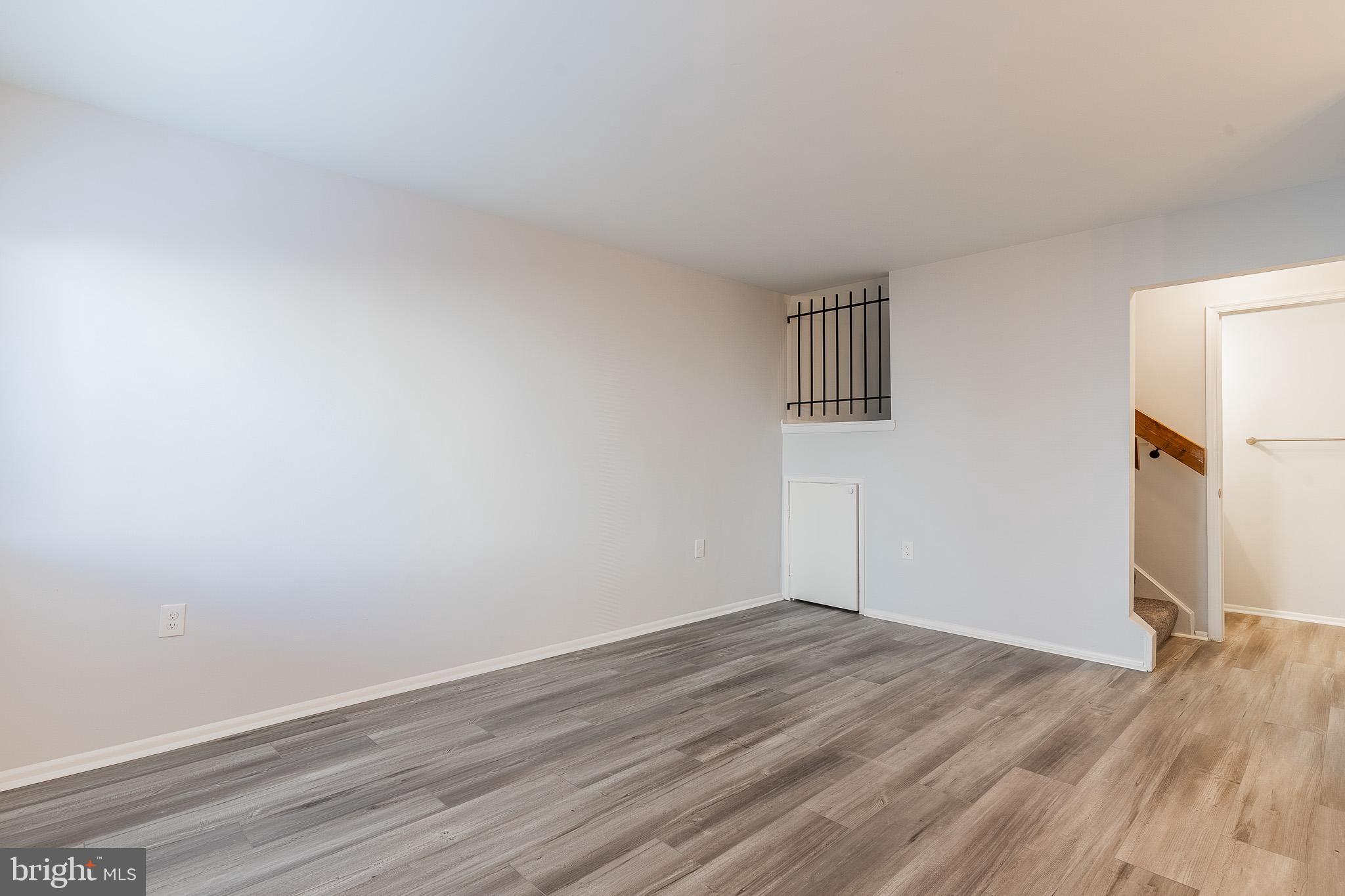 8708 Village Square Drive Alexandria, VA 22309 - Photo 8 of 46 a view of an empty room with wooden floor and a window
