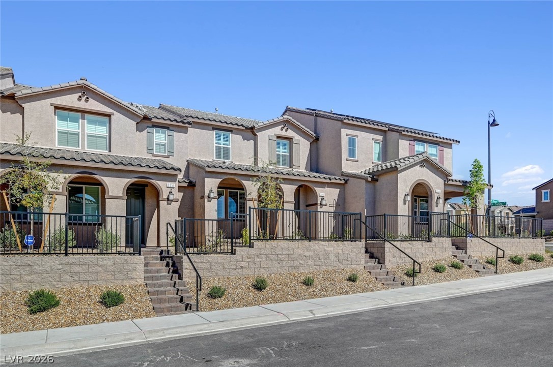 3548 Dimora Street Henderson, NV 89044 - Photo 2 of 40 Townhome / multi-family property featuring stucco siding, a tile roof, a porch, and stairs