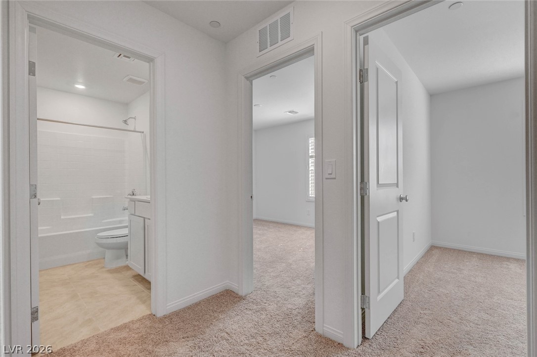3548 Dimora Street Henderson, NV 89044 - Photo 24 of 40 Hallway featuring baseboards, visible vents, and carpet floors