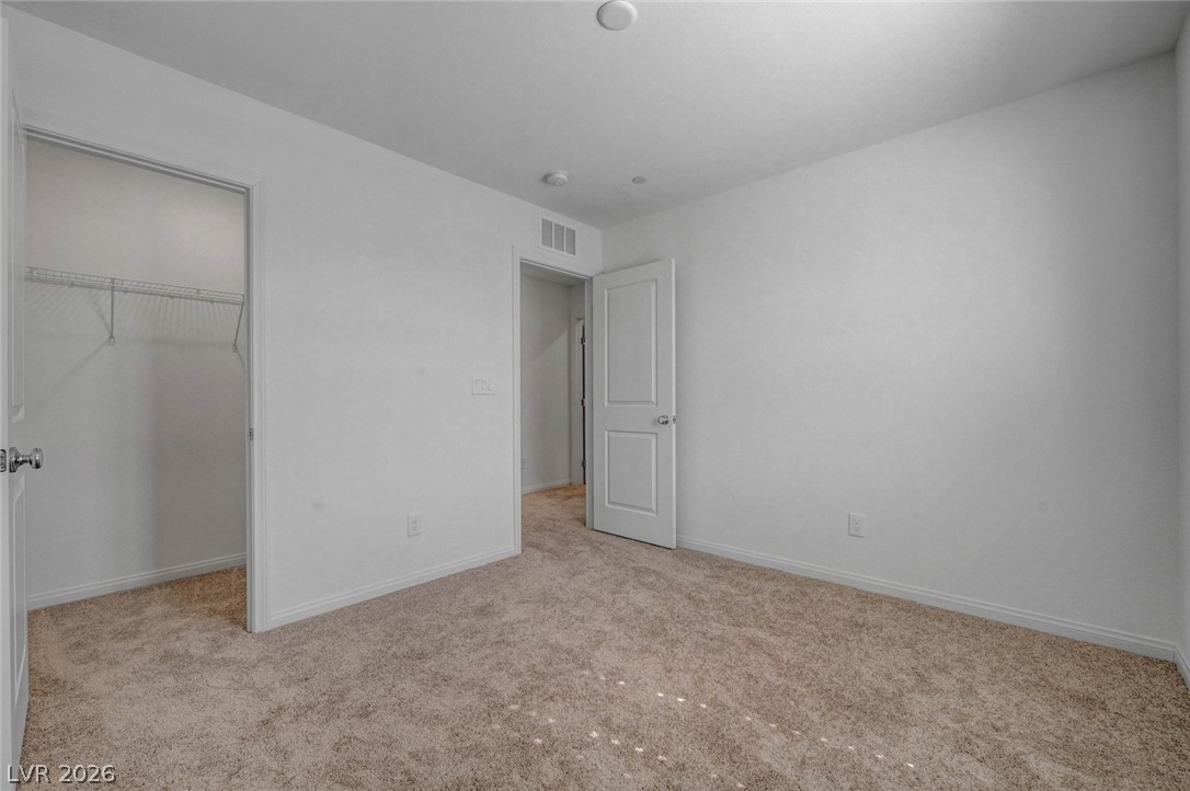 3548 Dimora Street Henderson, NV 89044 - Photo 26 of 40 Unfurnished bedroom with carpet floors, a closet, visible vents, and baseboards
