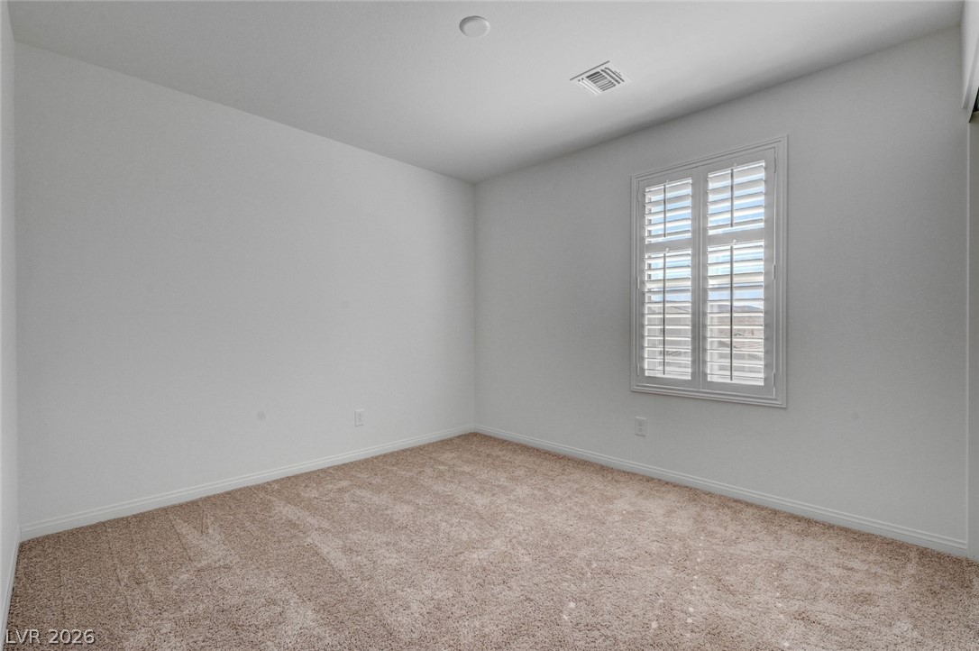 3548 Dimora Street Henderson, NV 89044 - Photo 27 of 40 Empty room featuring carpet floors, visible vents, and baseboards