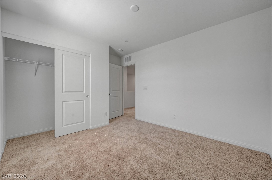 3548 Dimora Street Henderson, NV 89044 - Photo 28 of 40 Unfurnished bedroom with a closet, visible vents, baseboards, and light carpet