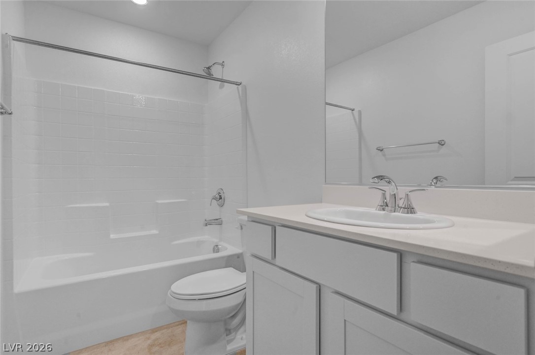 3548 Dimora Street Henderson, NV 89044 - Photo 29 of 40 Full bath featuring toilet, vanity, tile patterned floors, and shower combination