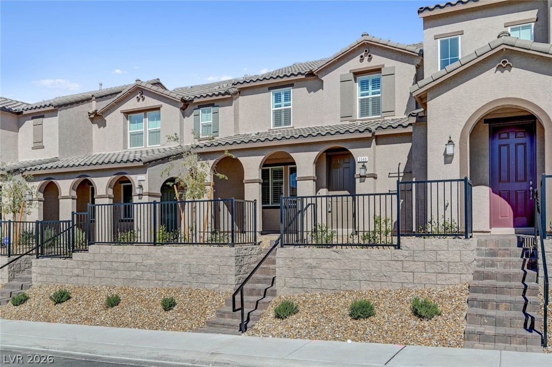 3548 Dimora Street Henderson, NV 89044 - Photo 3 of 40 View of front of house featuring a porch, a tiled roof, and stucco siding