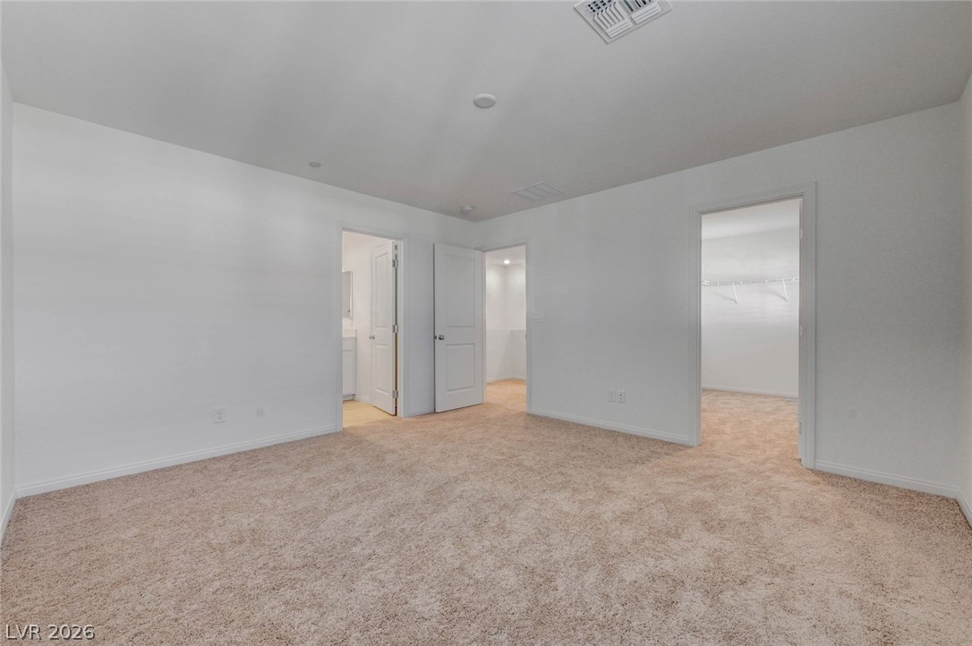 3548 Dimora Street Henderson, NV 89044 - Photo 32 of 40 Unfurnished bedroom with a spacious closet, baseboards, visible vents, and carpet