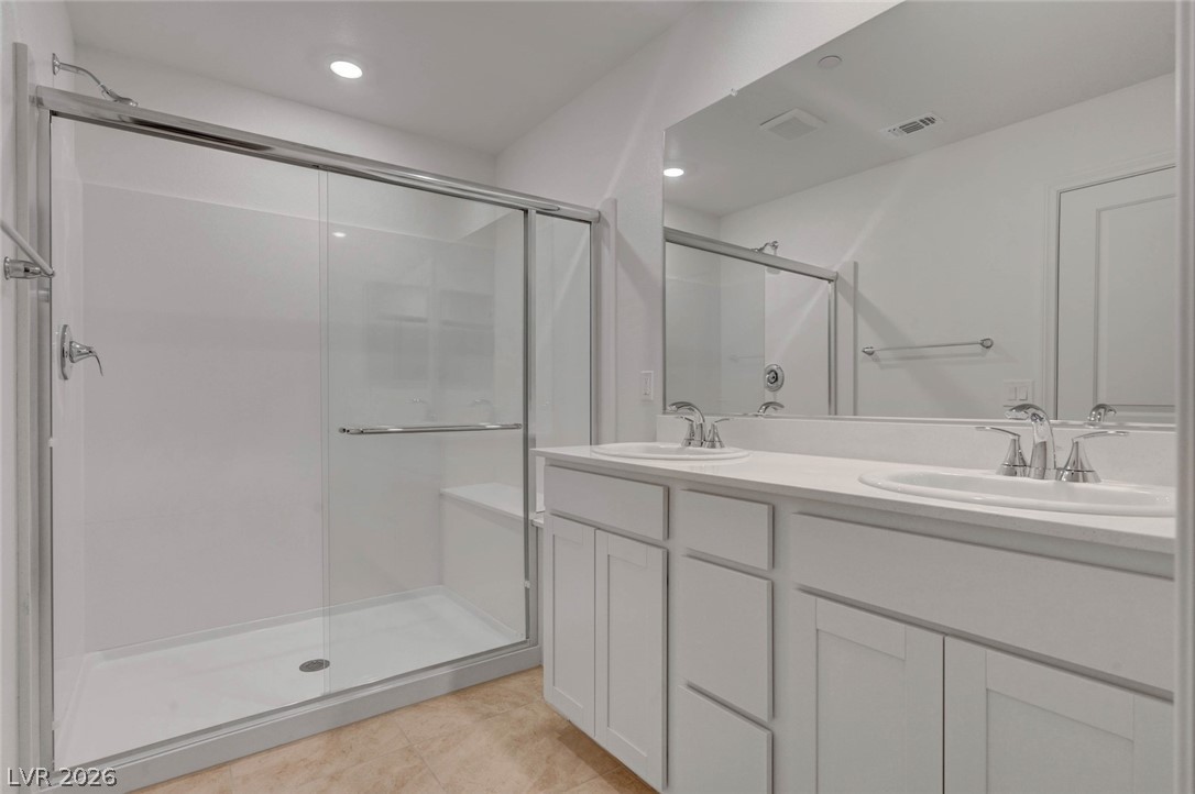 3548 Dimora Street Henderson, NV 89044 - Photo 34 of 40 Bathroom with double vanity, a stall shower, and a sink