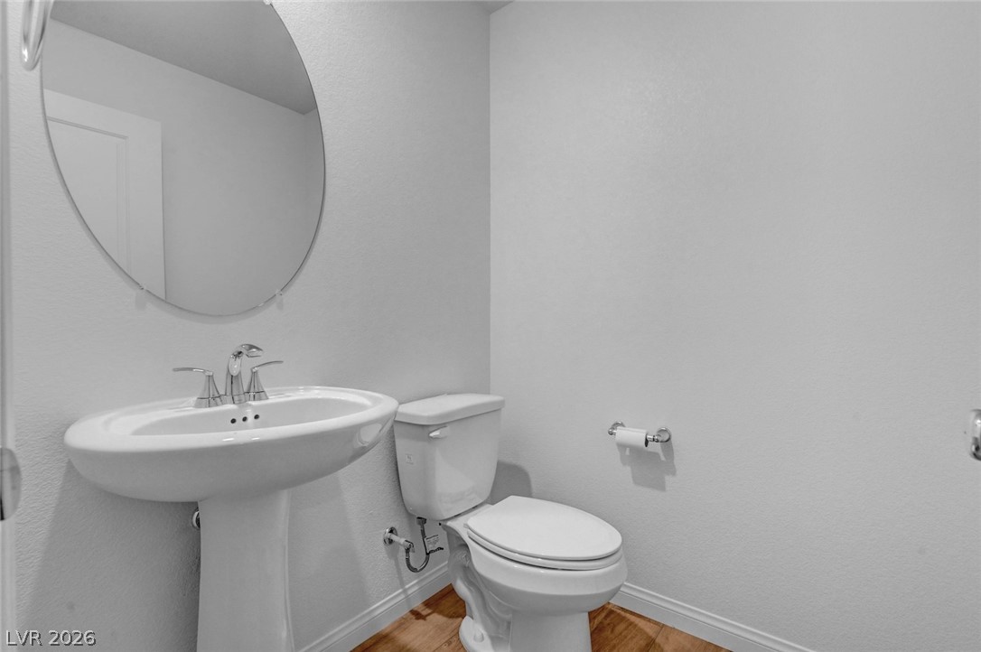 3548 Dimora Street Henderson, NV 89044 - Photo 35 of 40 Bathroom featuring baseboards, wood finished floors, and toilet