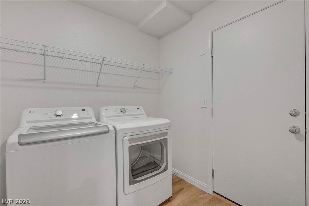 3548 Dimora Street Henderson, NV 89044 - Photo 36 of 40 Clothes washing area with light wood-style floors, baseboards, separate washer and dryer, and laundry area