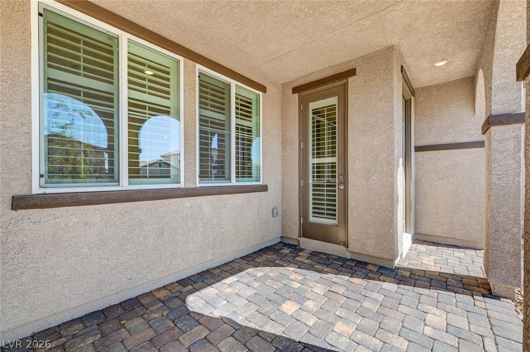 3548 Dimora Street Henderson, NV 89044 - Photo 6 of 40 View of exterior entry with stucco siding and a patio