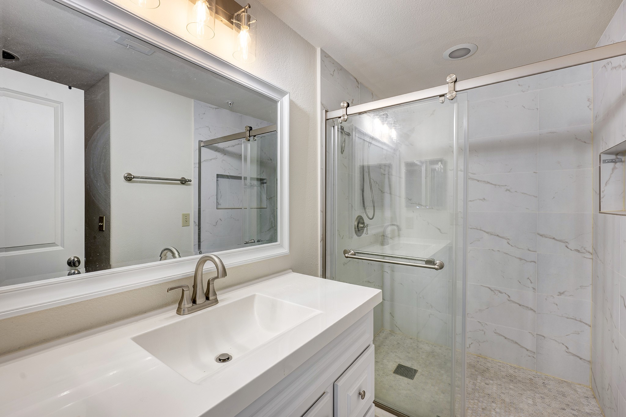 1602 Elgin Street, Unit 13 Houston, TX 77004 - Photo 11 of 18 a bathroom with a shower sink vanity and mirror