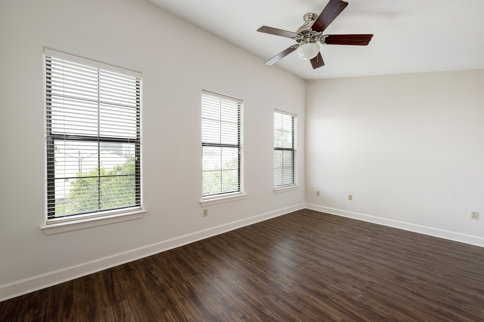 1602 Elgin Street, Unit 13 Houston, TX 77004 - Photo 13 of 18 a view of an empty room with wooden floor and a window