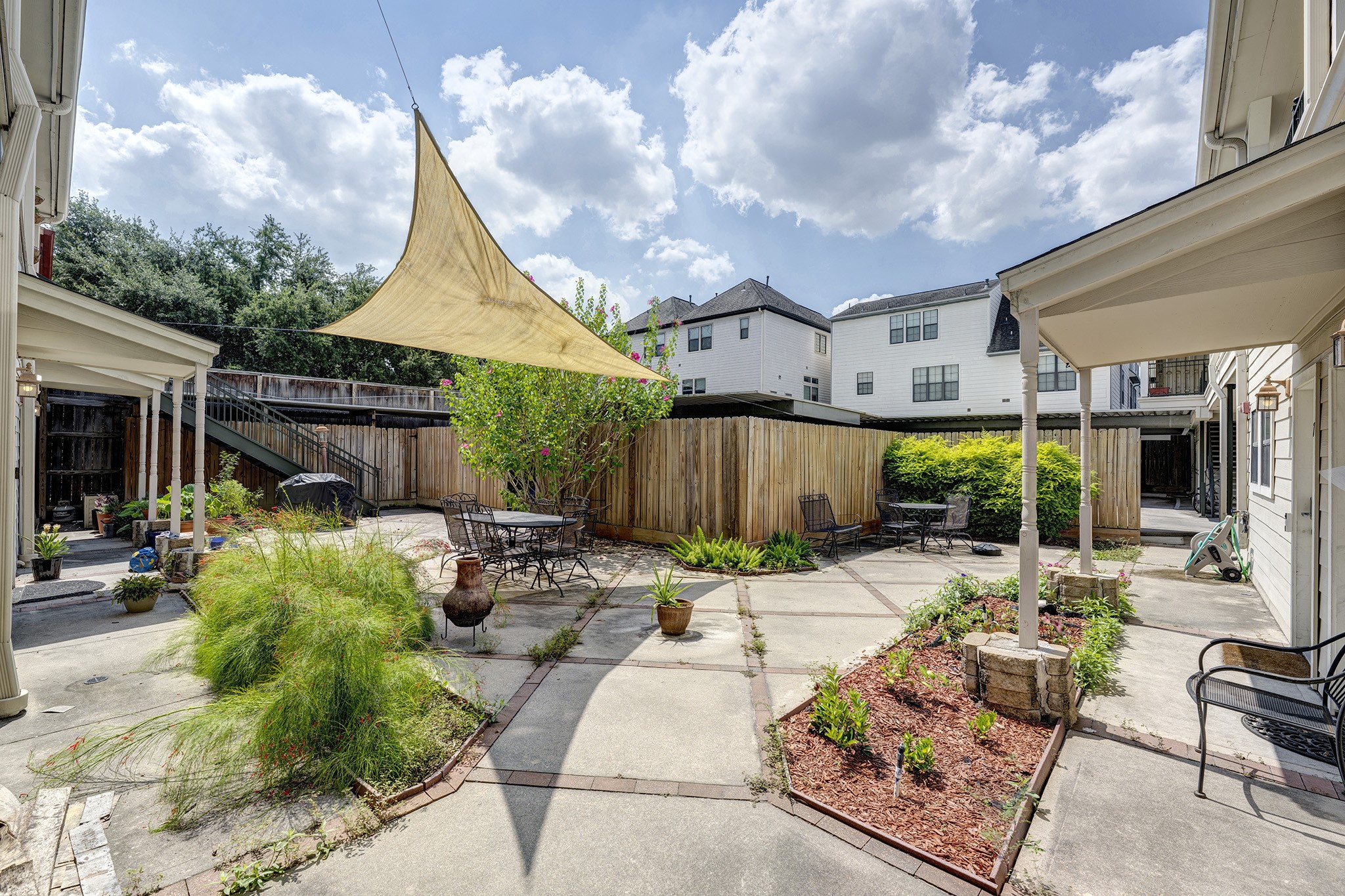 1602 Elgin Street, Unit 13 Houston, TX 77004 - Photo 16 of 18 a patio with patio a couch and potted plants