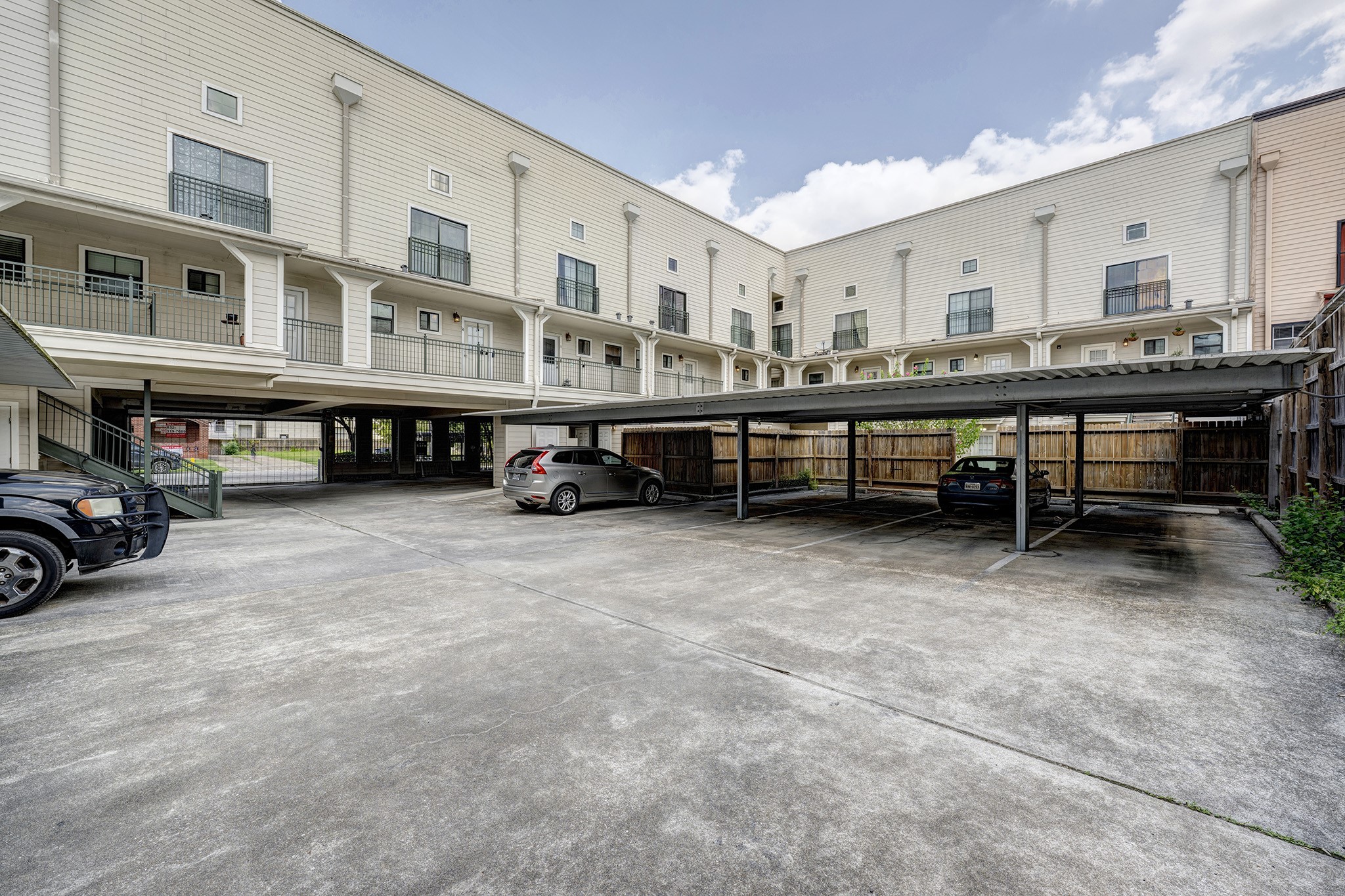 1602 Elgin Street, Unit 13 Houston, TX 77004 - Photo 18 of 18 a view of a cars park in front of house