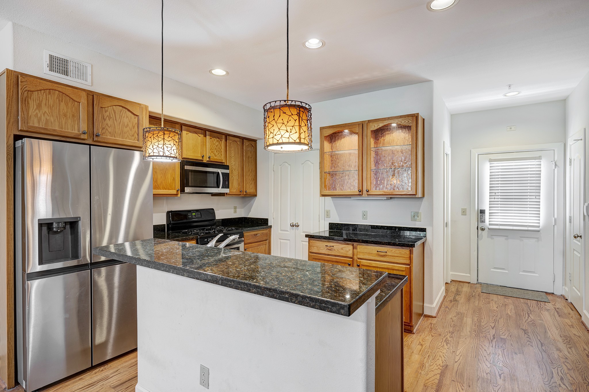 1602 Elgin Street, Unit 13 Houston, TX 77004 - Photo 3 of 18 a kitchen with stainless steel appliances granite countertop a sink a stove and refrigerator