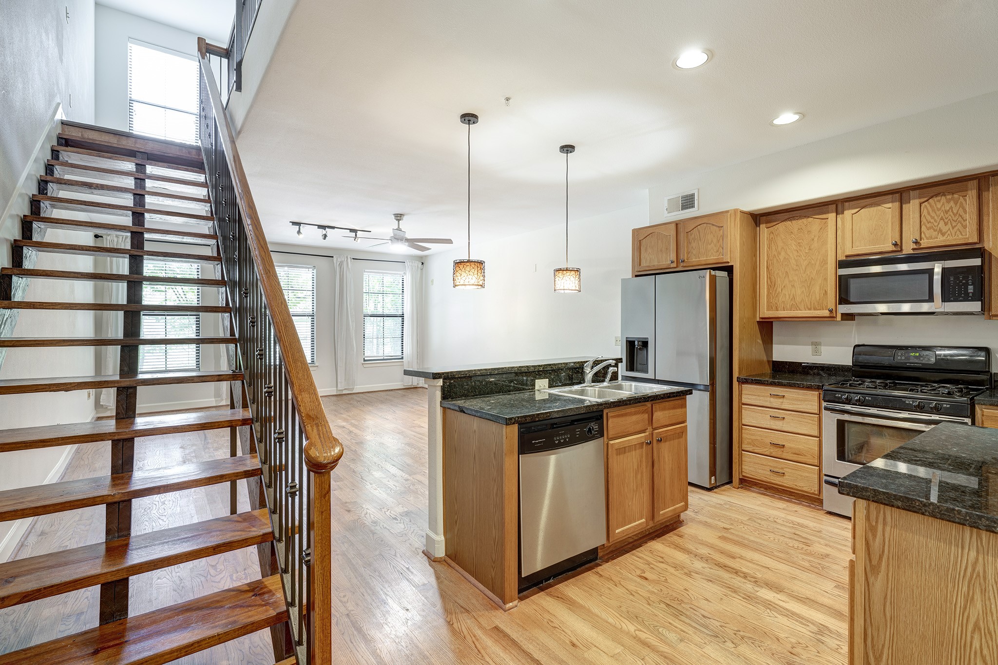 1602 Elgin Street, Unit 13 Houston, TX 77004 - Photo 6 of 18 a kitchen with stainless steel appliances granite countertop a stove and a refrigerator