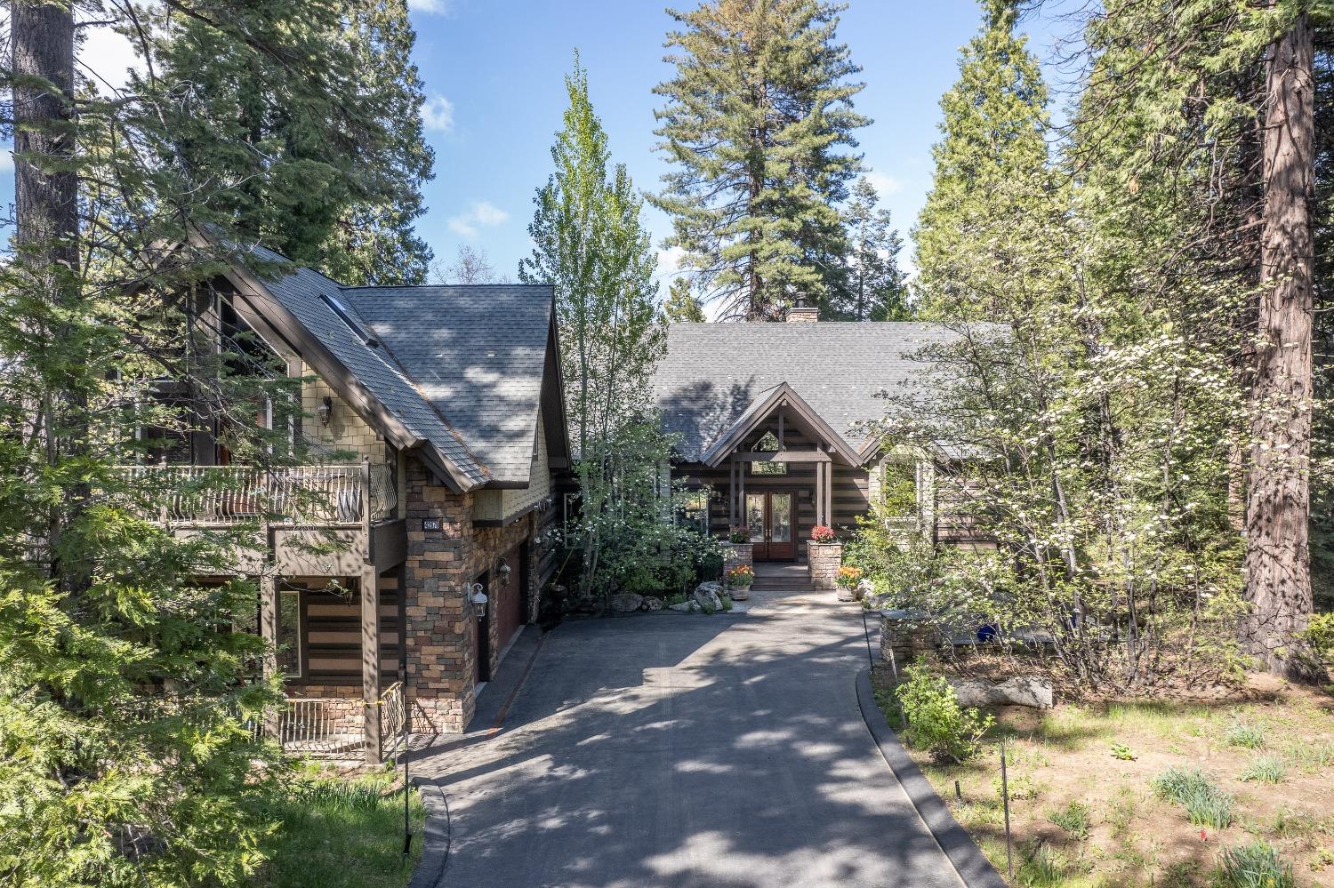 42676 Granite Circle Shaver Lake, CA 93664 - Photo 1 of 99 a view of a house with a tree in the background