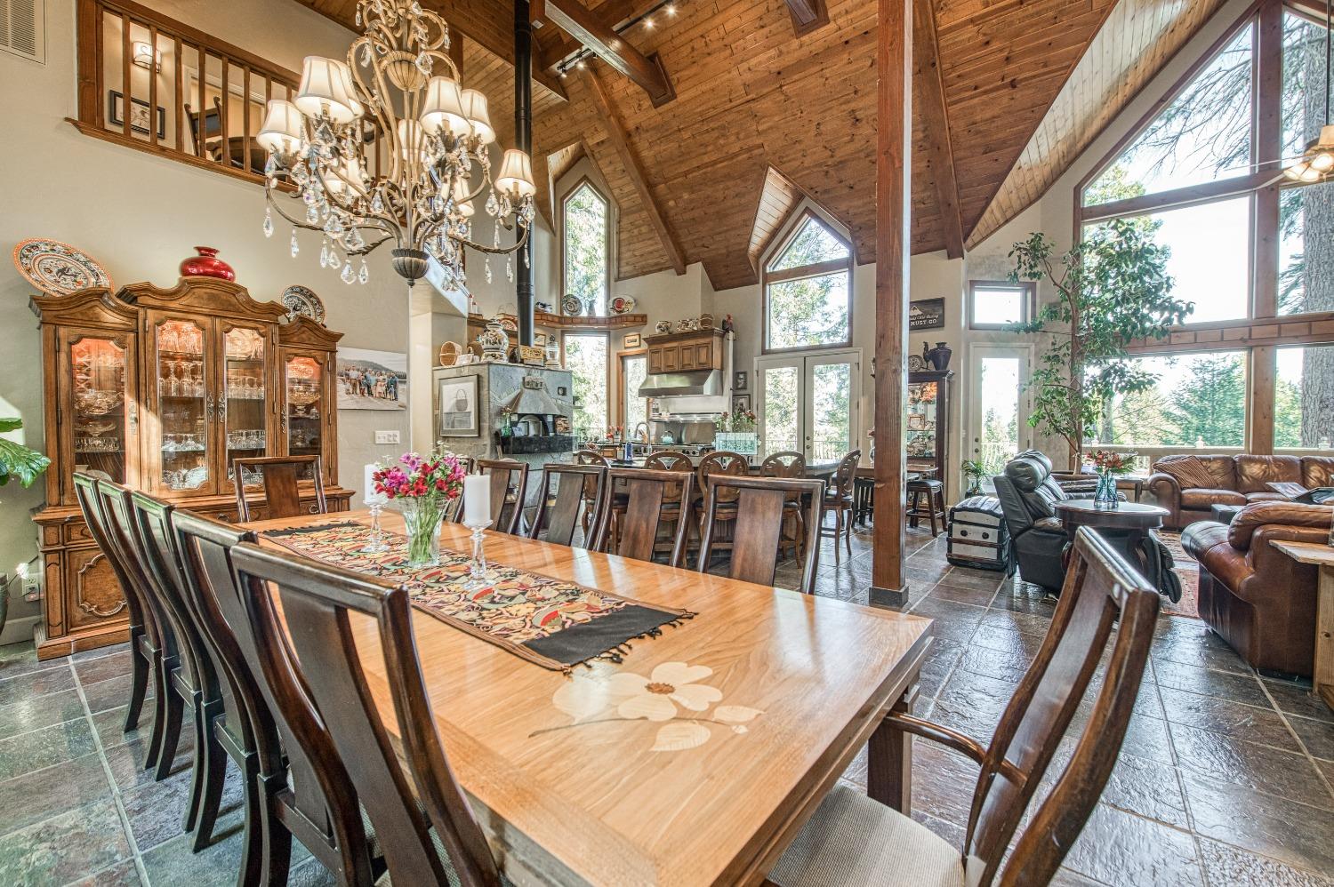 42676 Granite Circle Shaver Lake, CA 93664 - Photo 11 of 99 a view of a dining room with furniture large windows and wooden floor