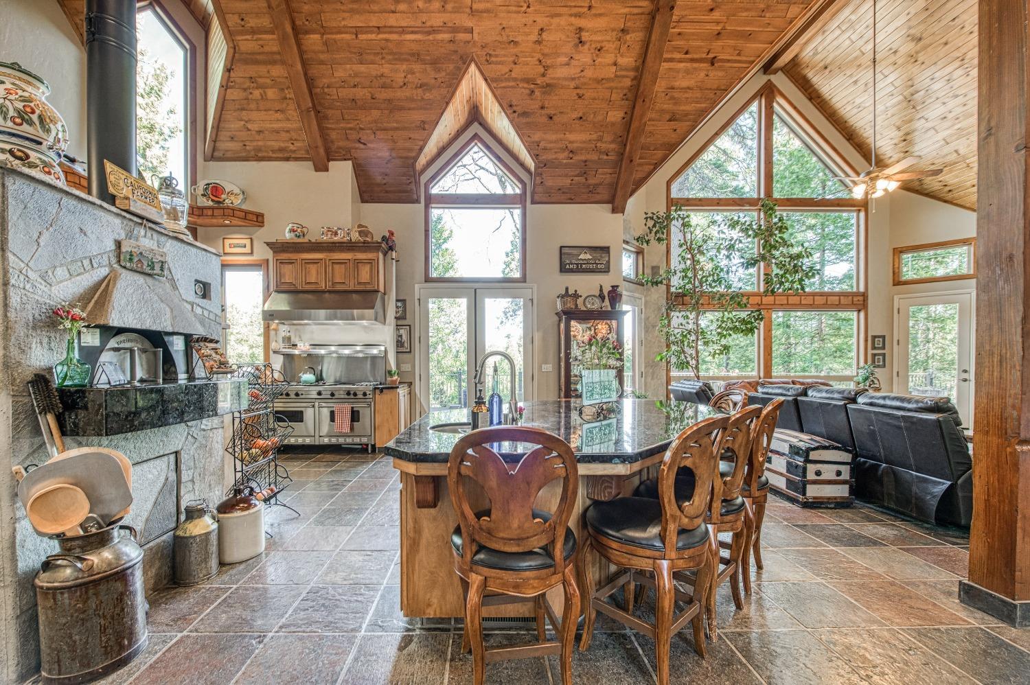 42676 Granite Circle Shaver Lake, CA 93664 - Photo 13 of 99 a view of a dining room with furniture water view and a fireplace
