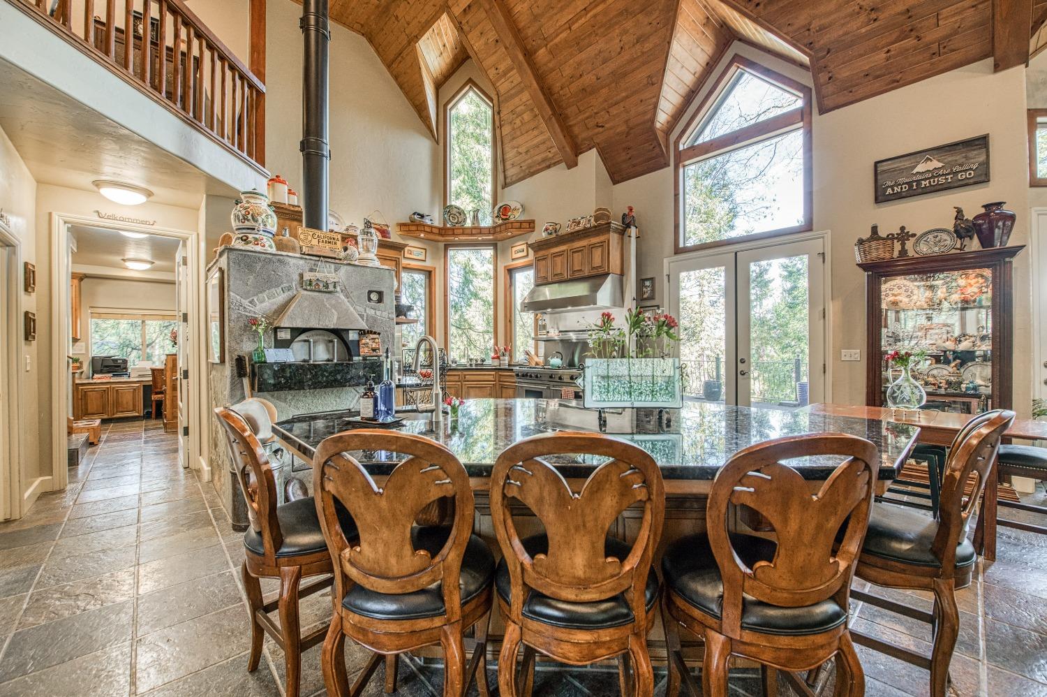 42676 Granite Circle Shaver Lake, CA 93664 - Photo 14 of 99 a dining room with furniture a chandelier and fireplace