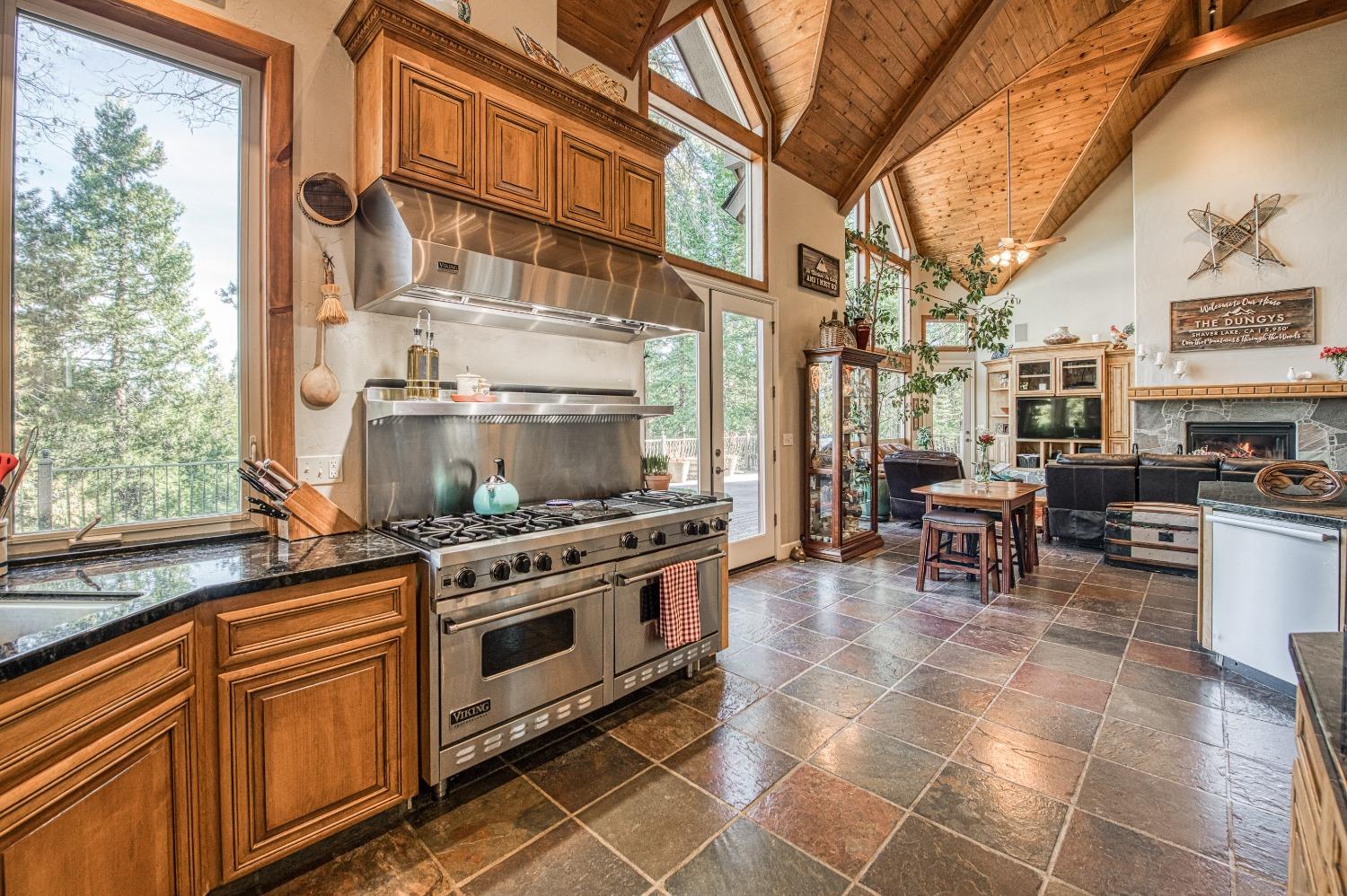 42676 Granite Circle Shaver Lake, CA 93664 - Photo 22 of 99 a kitchen with stainless steel appliances granite countertop a stove a sink and a microwave