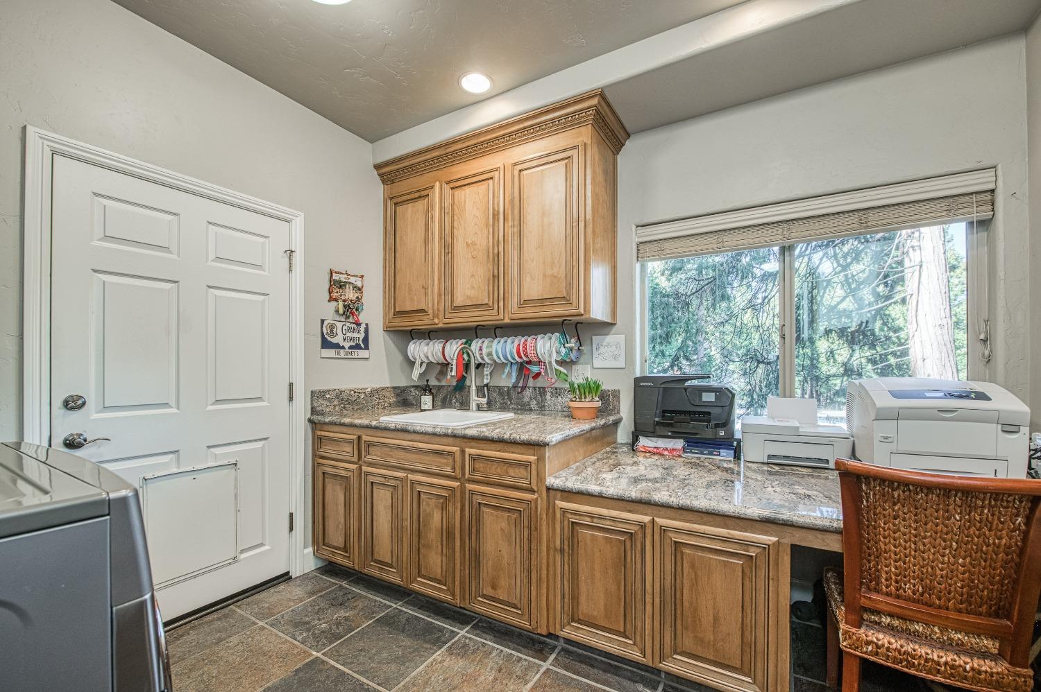 42676 Granite Circle Shaver Lake, CA 93664 - Photo 23 of 99 a kitchen with granite countertop a stove sink and cabinets
