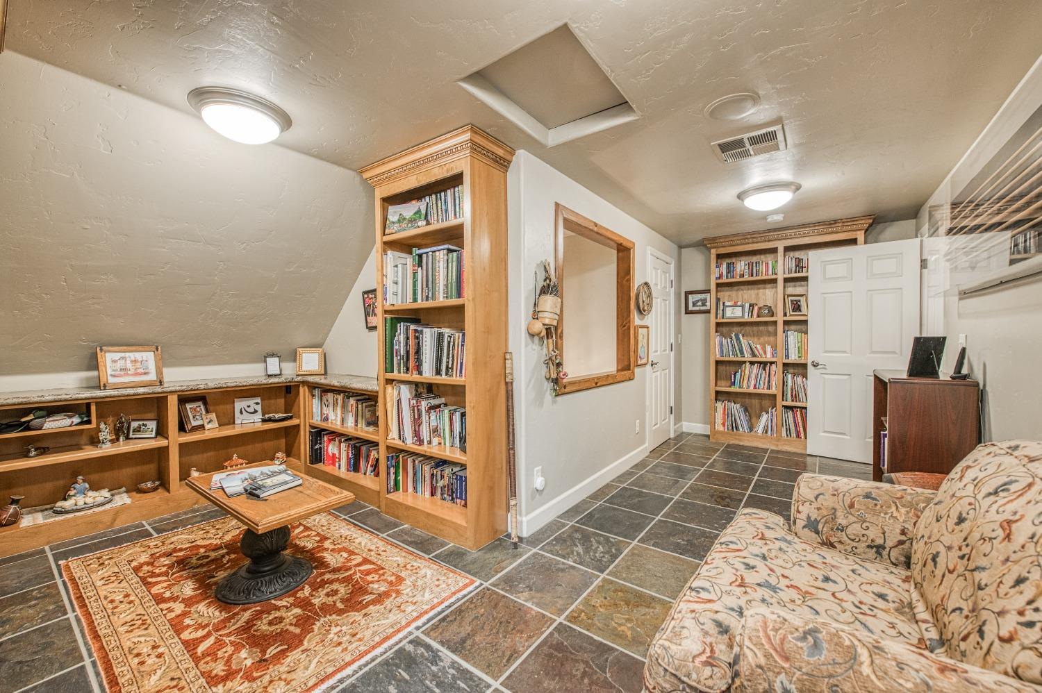 42676 Granite Circle Shaver Lake, CA 93664 - Photo 32 of 99 a bedroom with furniture and a book shelf