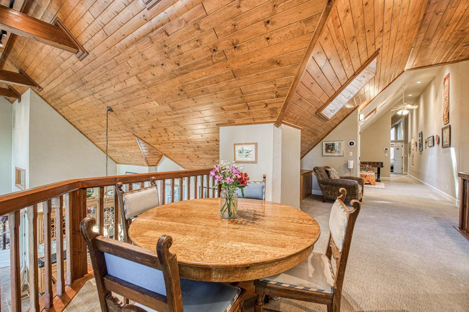 42676 Granite Circle Shaver Lake, CA 93664 - Photo 38 of 99 a roof deck with table and chairs and potted plants