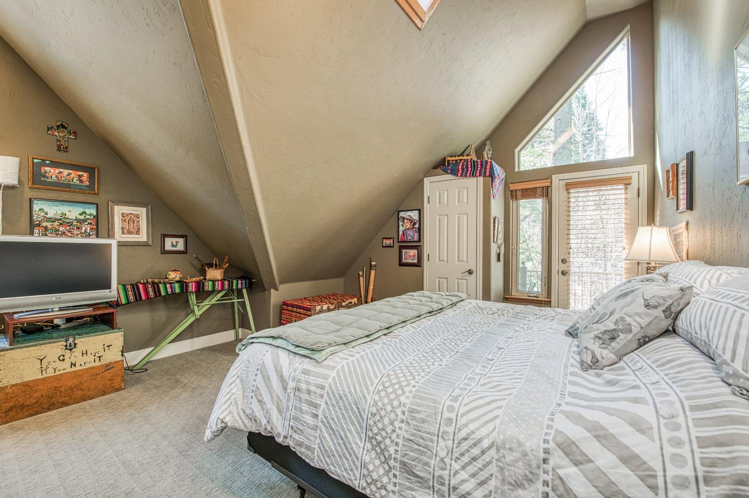 42676 Granite Circle Shaver Lake, CA 93664 - Photo 47 of 99 a bedroom with a bed and a flat tv screen next to a window