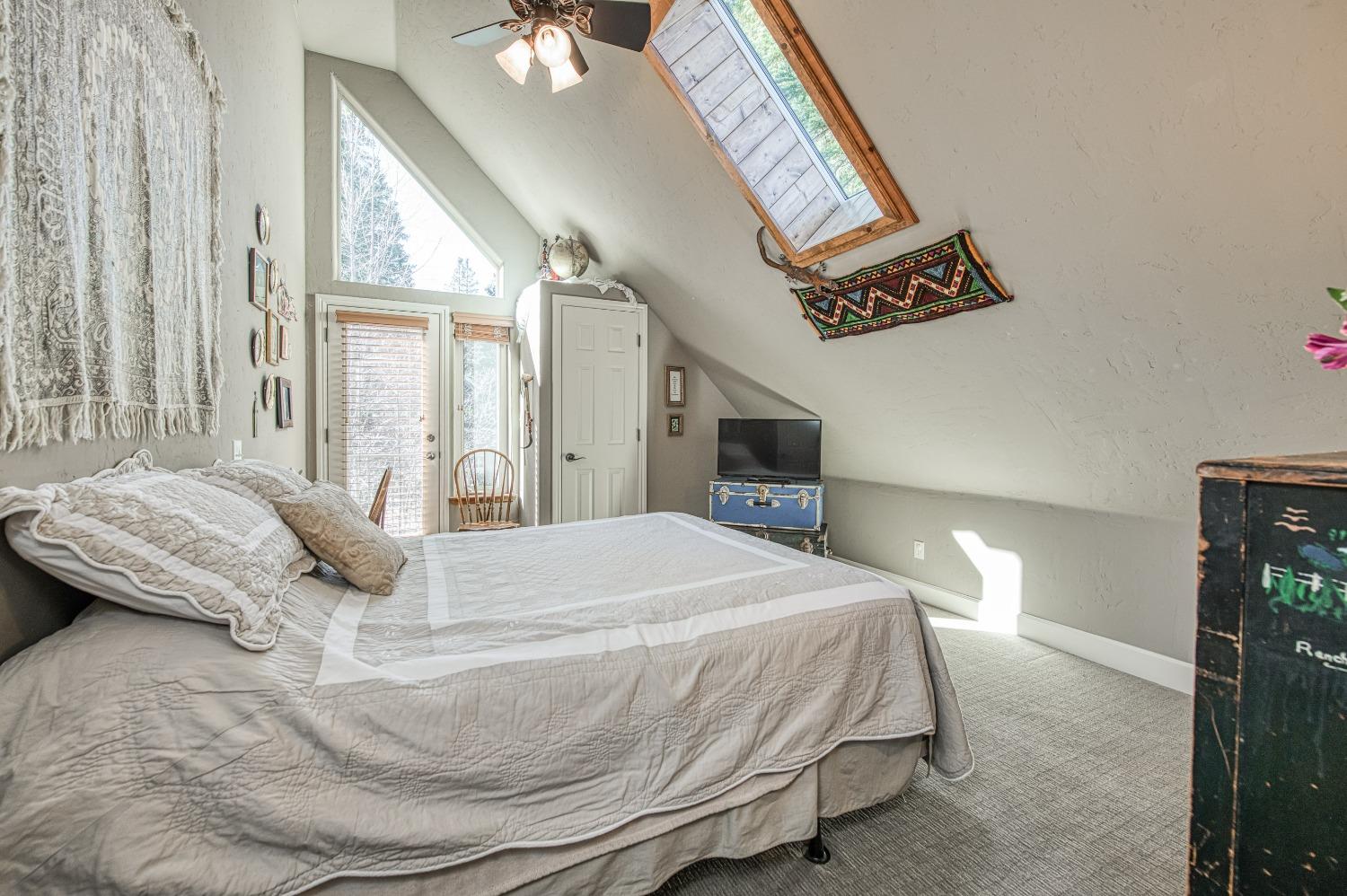 42676 Granite Circle Shaver Lake, CA 93664 - Photo 51 of 99 a bedroom with a bed and a chandelier