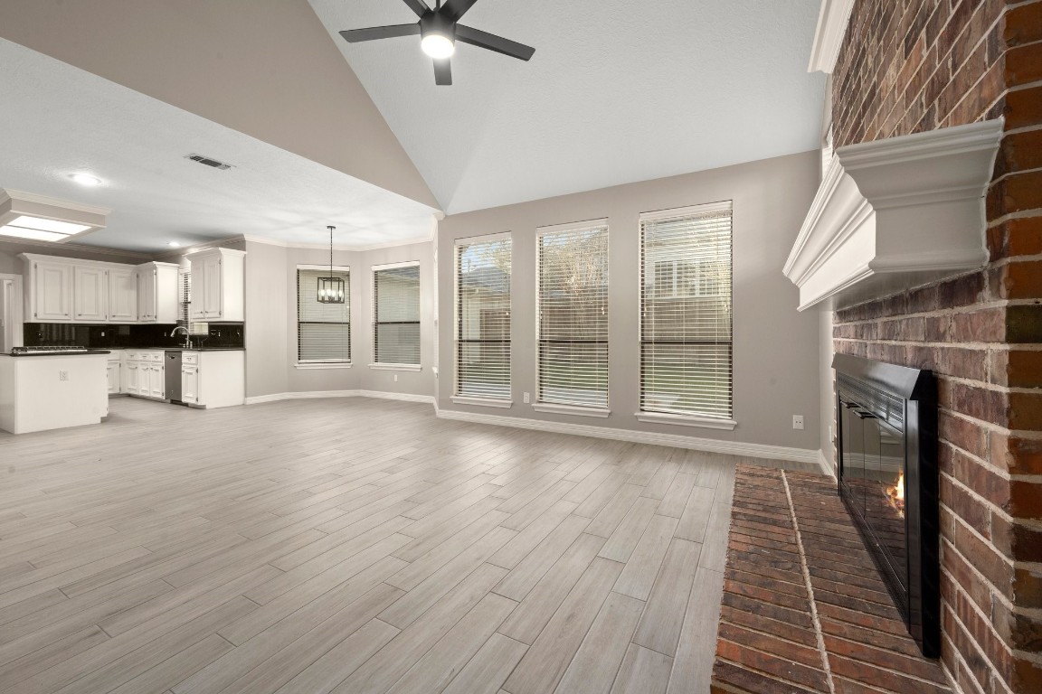 8222 Redchurch Drive Spring, TX 77379 - Photo 16 of 36 a view of a electric room with wooden floor and a kitchen