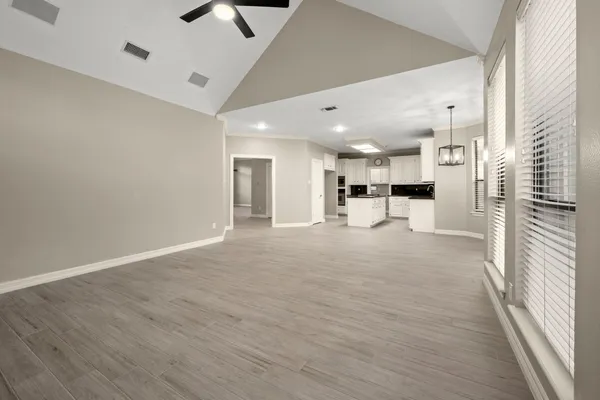 a view of a kitchen with a refrigerator and a window