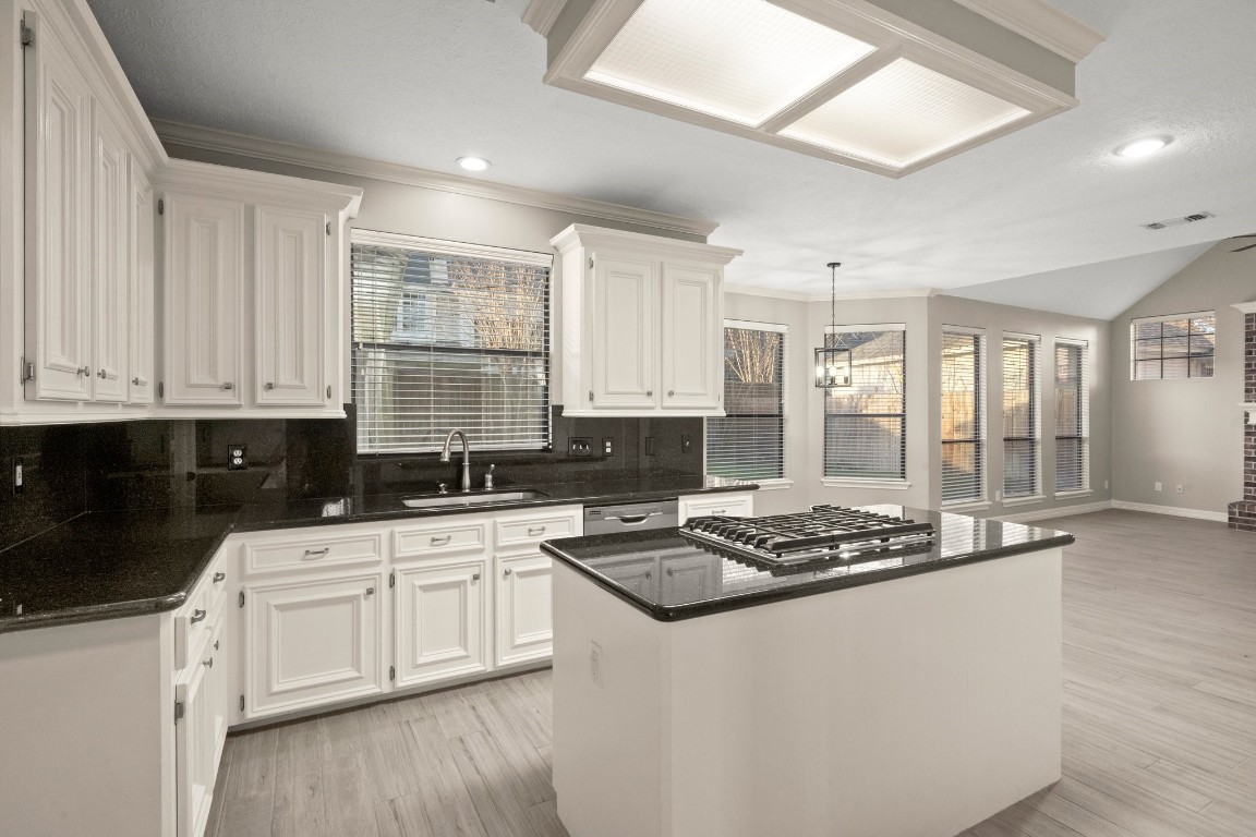 8222 Redchurch Drive Spring, TX 77379 - Photo 21 of 36 a kitchen with stainless steel appliances a white stove top oven and white cabinets