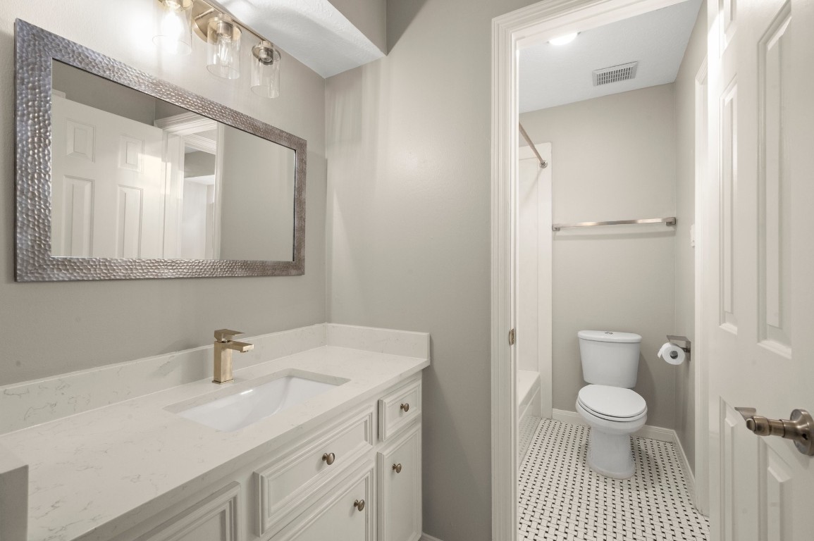 8222 Redchurch Drive Spring, TX 77379 - Photo 30 of 36 a bathroom with a sink a toilet and a mirror