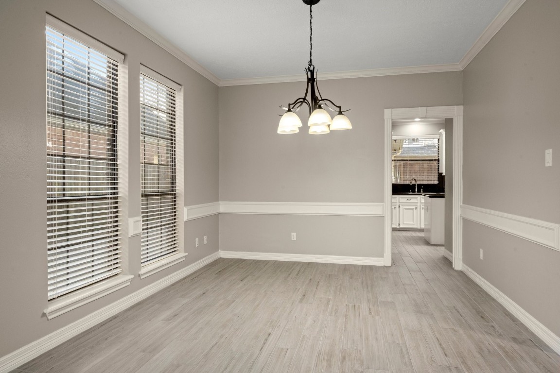 8222 Redchurch Drive Spring, TX 77379 - Photo 8 of 36 a view of empty room with wooden floor and fan