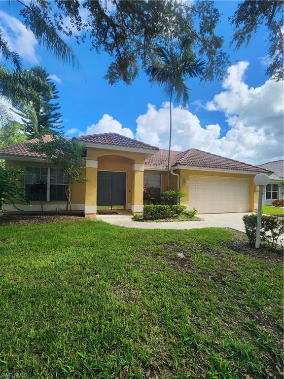 12691 Eagle Pointe Circle Fort Myers, FL 33913 - Photo 1 of 22 View of front of property featuring a garage, a tiled roof, stucco siding, a front yard, and driveway