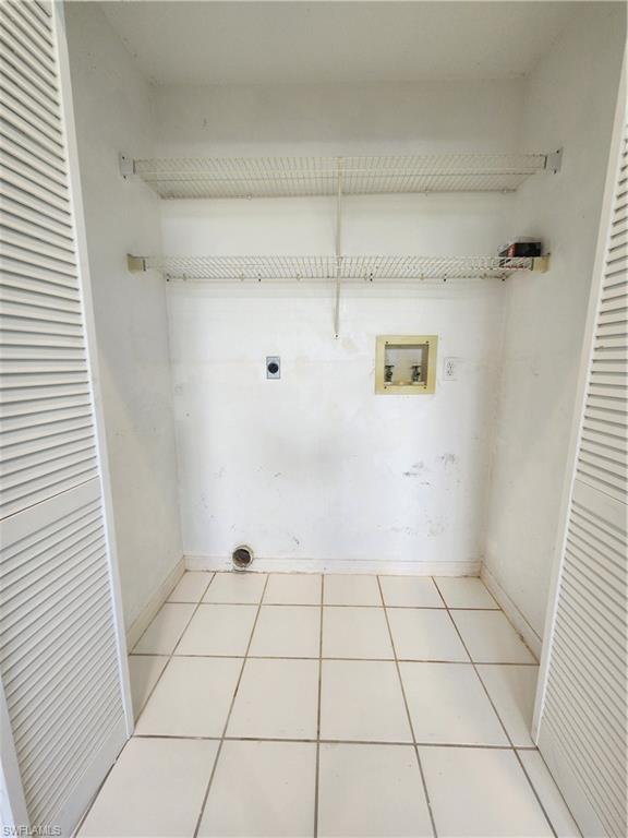 12691 Eagle Pointe Circle Fort Myers, FL 33913 - Photo 8 of 22 Laundry room featuring hookup for a washing machine, light tile patterned flooring, and hookup for an electric dryer