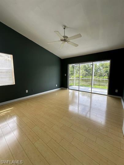 12691 Eagle Pointe Circle Fort Myers, FL 33913 - Photo 9 of 22 Spare room with baseboards, light wood finished floors, ceiling fan, and vaulted ceiling