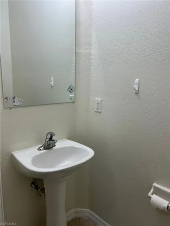 a white toilet sitting next to a white wall