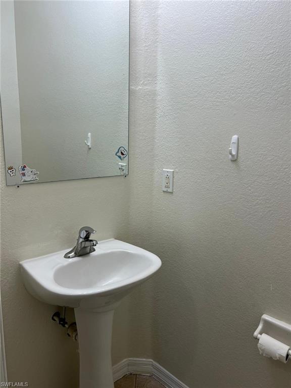 7515 Bristol Circle Naples, FL 34120 - Photo 17 of 42 a bathroom with a sink and mirror